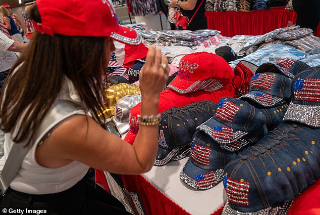 RNC attendees try on glittery hats with MAGA and American flag logos