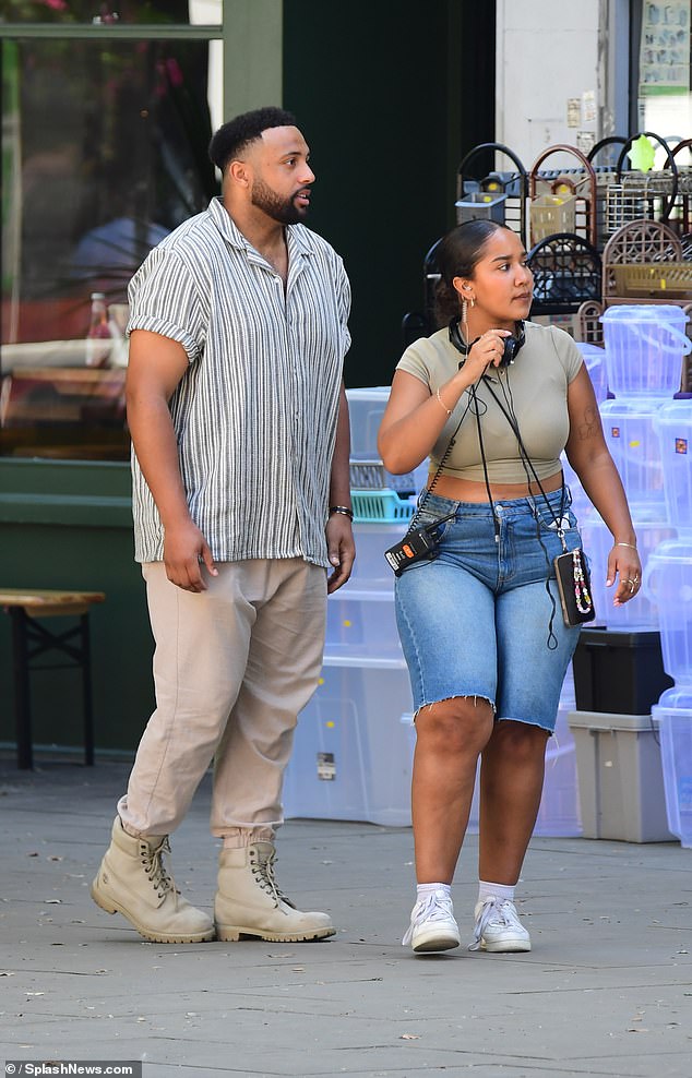 Meanwhile, her date wore an oversized striped shirt with cargo pants and boots