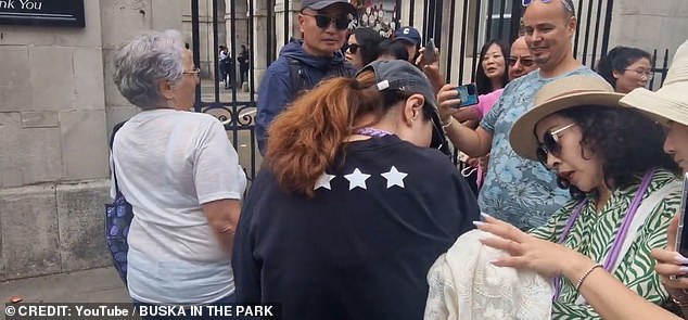 A group tends to the woman's arm after she was bitten by the horse