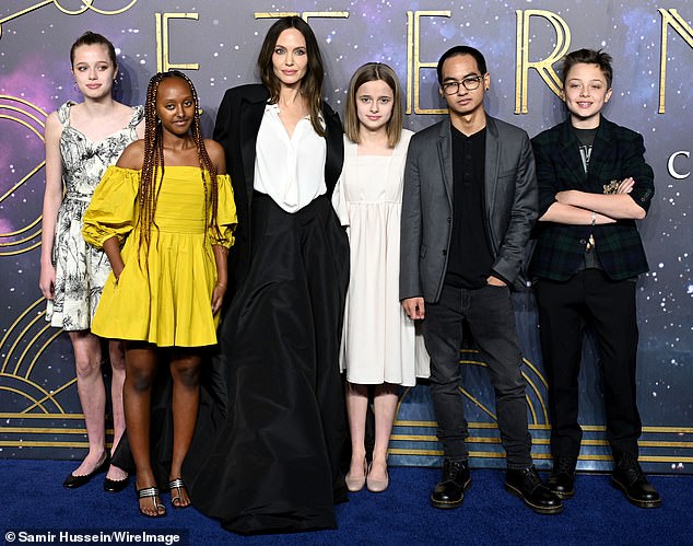 Shiloh now goes by only his mother's last name, Jolie; Angelina pictured with five of her six children in October 2021; L-R Shiloh, Zahara, Angelina, Vivienne, Maddox and Knox