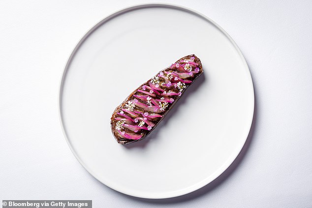 Wells criticized the three-Michelin-starred restaurant Eleven Madison Park's 2021 all-vegan tasting menu (pictured, a plate of eggplant, tomato and coriander)