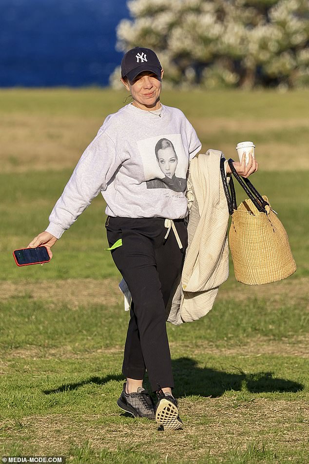 The former Home and Away star, 45, had a big smile on her face as she took her dog for a sunny walk in Coogee