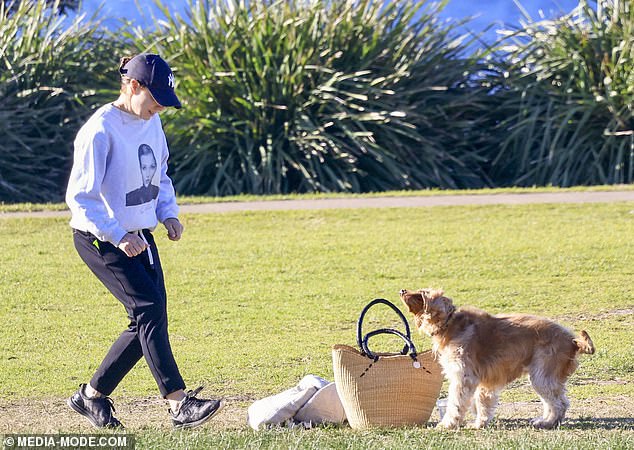 Kate was seen carrying her bag and a picnic blanket before laying the items out on the grass as she watched her dog run around