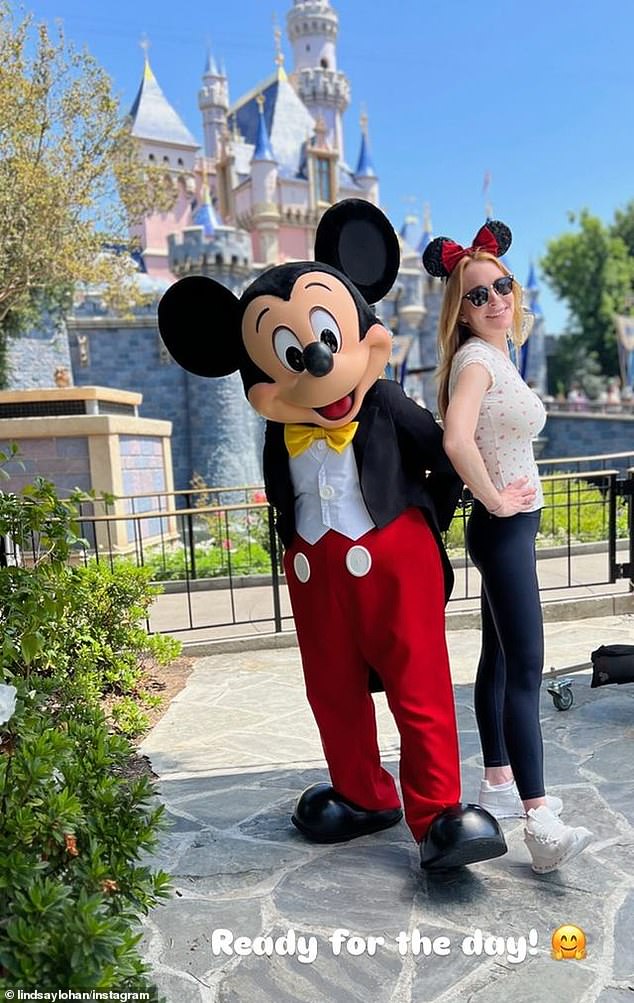 Lohan also shared a photo on Instagram Stories of herself posing with Mickey, announcing that she's 