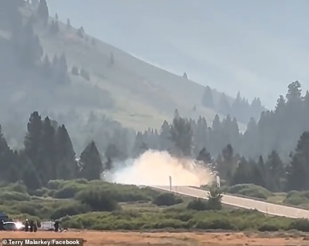 The black Porsche flew across the road, surrounded by lush greenery and mountain views, when it went up in smoke