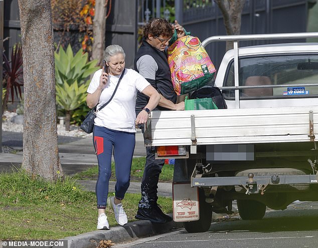 The Australian actor was spotted moving into a new home on Saturday with the help of a girlfriend (pictured)