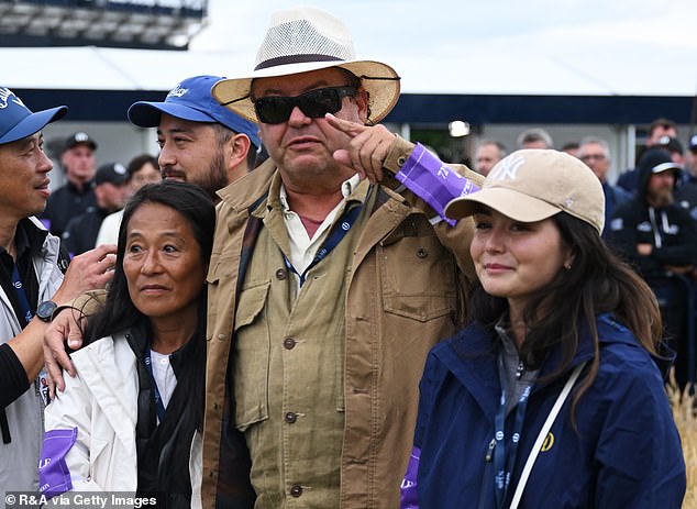 Maya appeared emotional as she waited to greet her husband on the 18th green