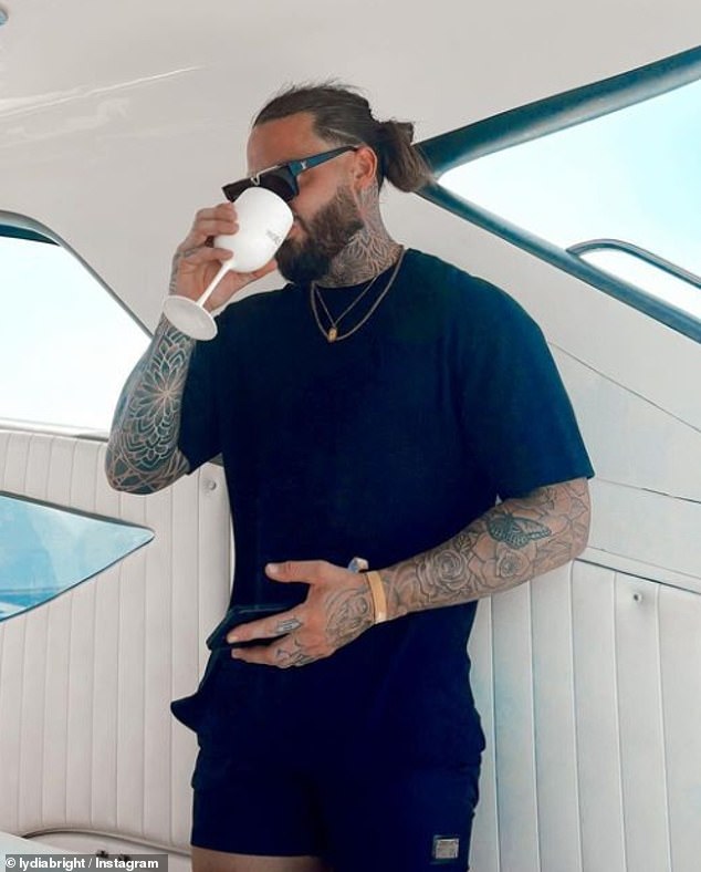 In another photo, Ben is seen drinking from a glass of wine while wearing a navy blue outfit on the luxury yacht in Spain.