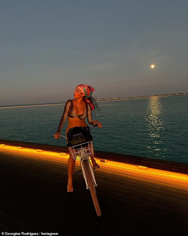 She showed off her stunning figure again in a long-sleeved leopard print bikini top and black bottoms as she enjoyed an evening bike ride