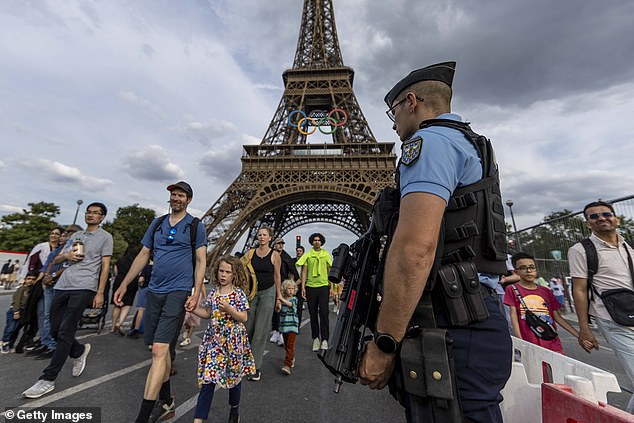 Police officer stands guard at the bridge near the Eiffel Tower on July 17, 2024 in Paris, France