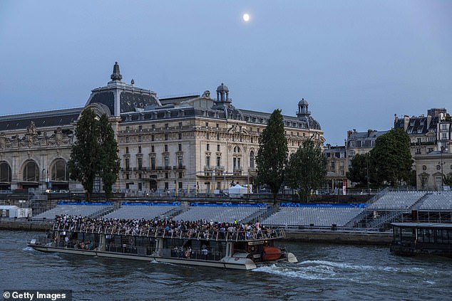 Empty chairs prepared for the opening ceremony are seen along the Seine River on July 17, 2024 in Paris