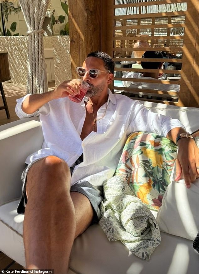 The former footballer and husband Rio, 45, looked every bit the holiday-ready as he wore a white linen shirt and matching swim shorts and sipped on a cocktail