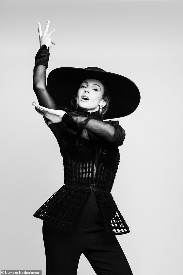 In another stylish black-and-white photo, the Our Girl star rocked a dramatic wide-brimmed hat and a semi-sheer top