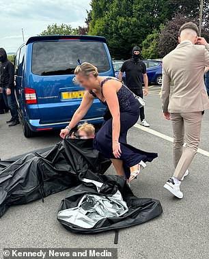 A friend emerges from his body bag