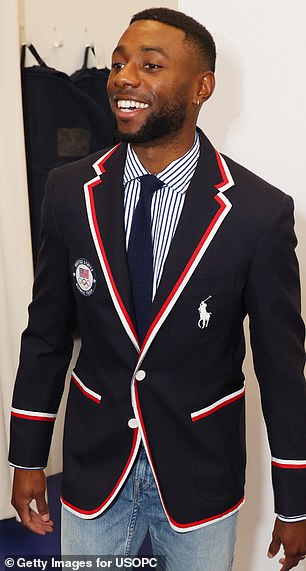 Athletes wear a navy blue jacket with white and red piping