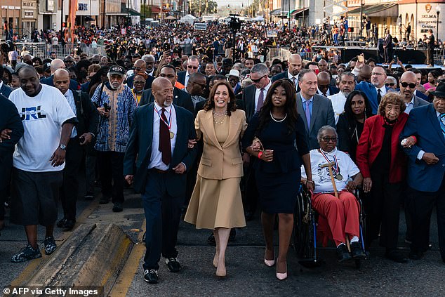 U.S. Vice President Kamala Harris (center) marches across the Edmund Pettus Bridge to commemorate the 57th anniversary of 