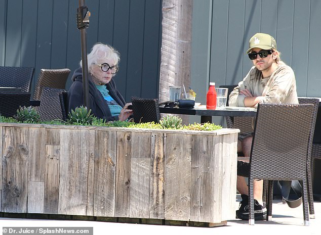 MacLaine, the older sister of fellow show business icon Warren Beatty, was photographed with her friend at an outside table at the cafe