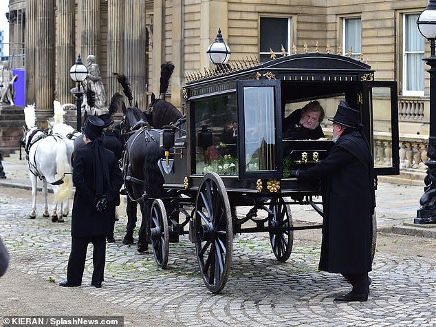 Elsewhere in the scenes, a man was seen lying in a coffin on the back of a horse and cart