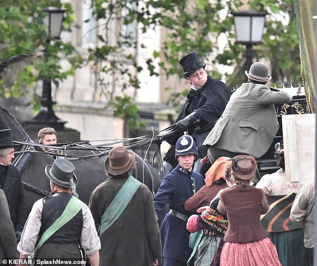 James later climbed onto a horse and carriage while several figures stood below shouting at the star