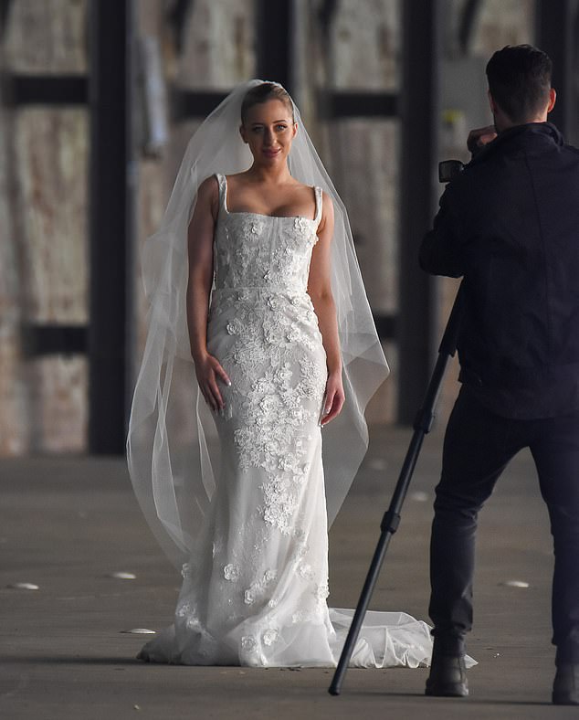 She added a flowing veil and opted for a sleek bridal makeup look as she pulled her hair back from her face