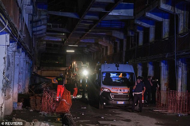 Of the 13 injured, seven are children. Pictured: An ambulance at the scene of the collapsed balcony in Naples yesterday