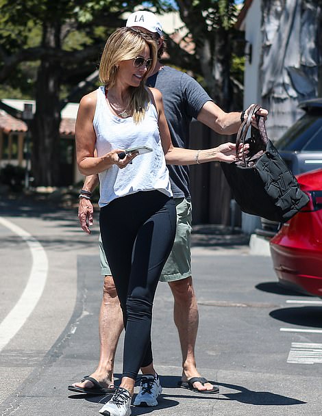 The couple held hands and joked together during a casual date