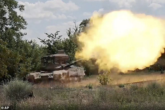 In this image, created from a video released by the Russian Ministry of Defense on Tuesday, July 16, 2024, a Russian tank fires at a Ukrainian position in an unknown location