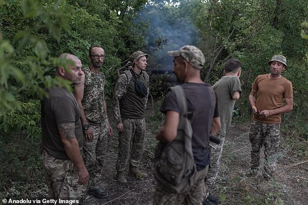 Ukrainian soldiers stand next to a tank in a rear position after an attack on Russian positions in the Donetsk region, Ukraine on July 20