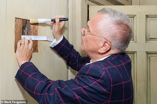 Professor Murray Pittock from the University of Glasgow with the hole, which is just 2.1cm (0.8in) wide