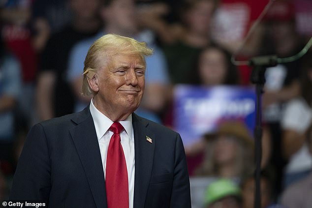 Trump (pictured at a rally in Grand Rapids, Michigan on Saturday) has a lead of at least 2 points and up to 9 percent over Harris