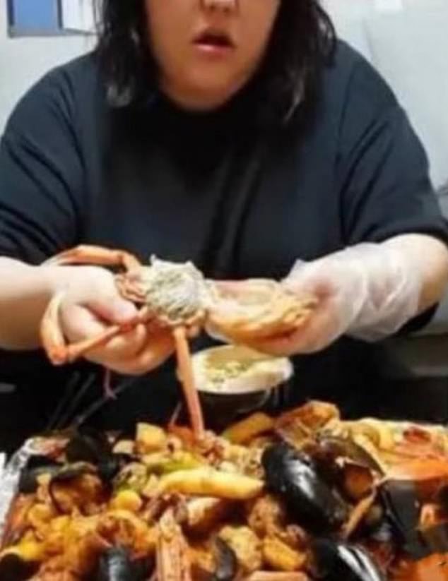 The 24-year-old content creator (pictured) made live streams in which she ate for up to 10 hours