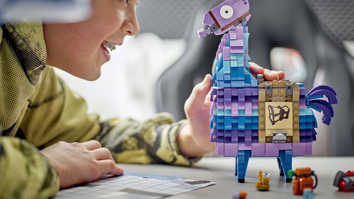 Supply Llama from Fortnite in Lego form. A child looks at it with a smile.