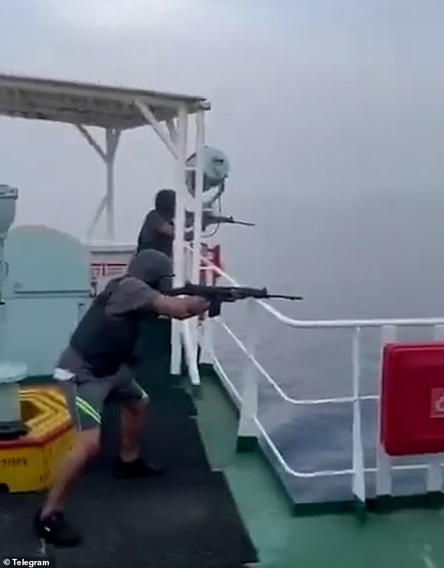 The crew members aboard the container ship open fire on the small boat before it explodes