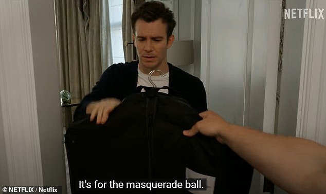 It shows him opening a door and being given a suit to wear to a masked ball - a hint at where his journey in the series will begin