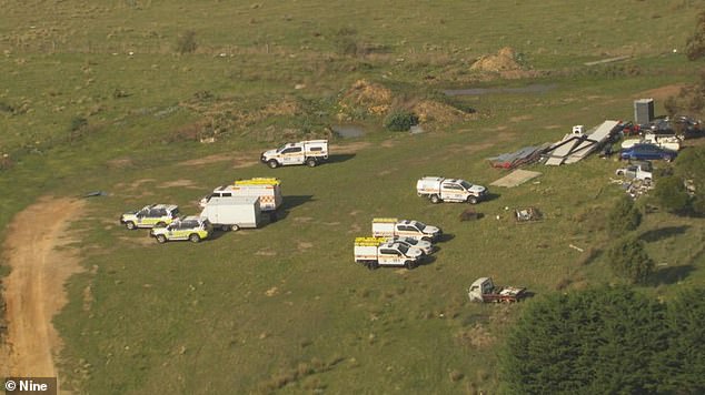 A man living in a bus on the property was arrested (photo shows police searching the large farmhouse)