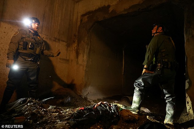 Agents from the U.S. Border Patrol's Confined Space Entry Team search a drainage system in El Paso, Texas, for migrants attempting to enter the United States from Mexico