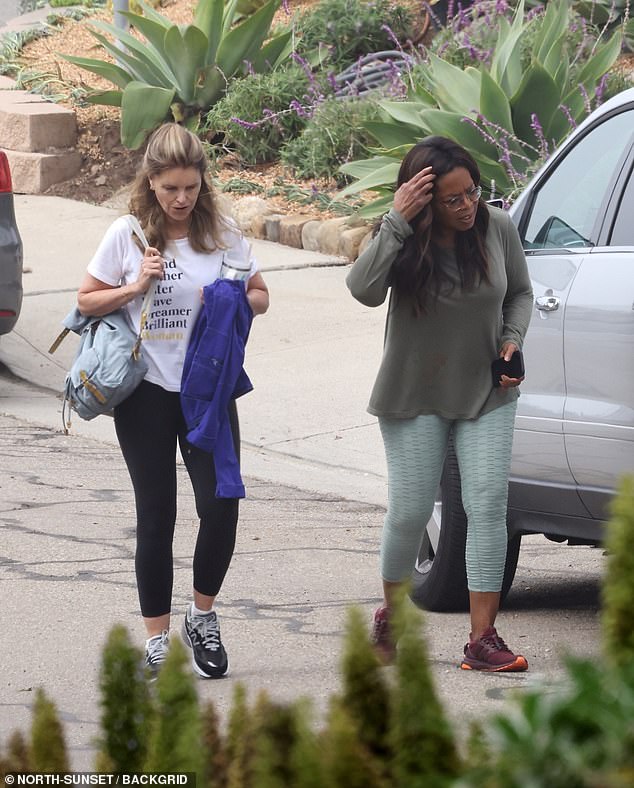 She paired it with light green cropped leggings with a textured pattern, which she contrasted with a pair of sleek burgundy Adidas Ultraboost sneakers from Beyoncé's Ivy Park collection.