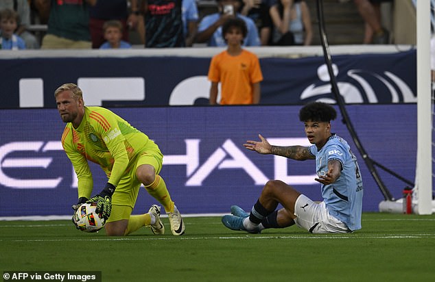 Manchester City's English midfielder, #75 Nico O'Reilly, gestures to Celtic's Danish goalkeeper, #01 Kasper Schmeichel, during the 2024 FC Series pre-season friendly.