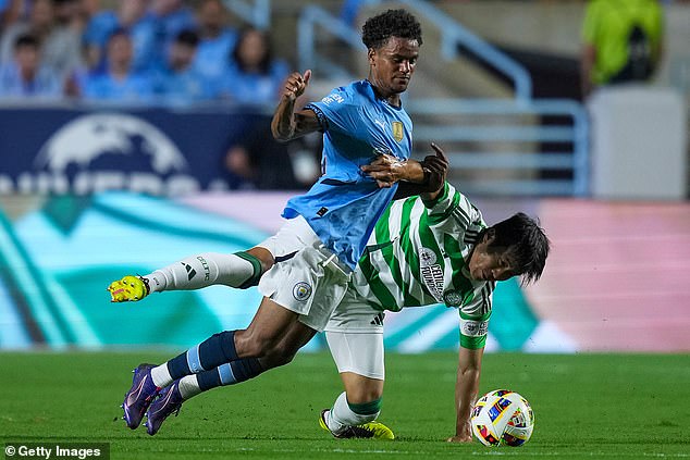 Celtic's Hyeok-Kyu Kwan #22 takes out Manchester City's Oscar Bobb #52