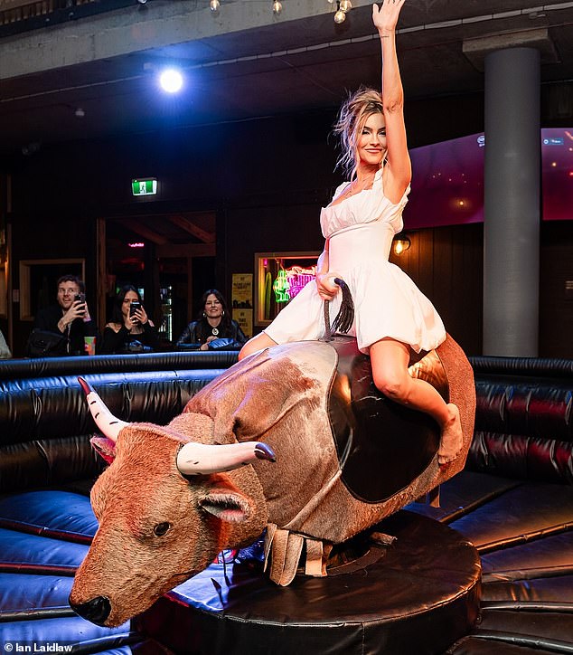 Later in the evening, the American TV star changed into a flowing white milkmaid-style dress and jumped on a mechanical bull for some fun.