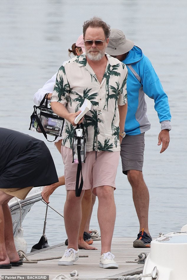 Rainn Wilson, best known for his role as Dwight Schrute on the NBC sitcom The Office, was also spotted on set wearing a short-sleeved shirt covered in green palm trees and light pink shorts.