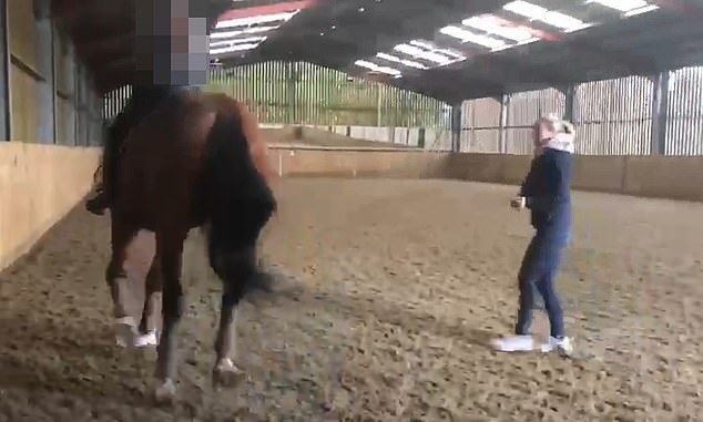 The footage shows her whipping the horse several times as she tries to teach it the 'piaffe'.