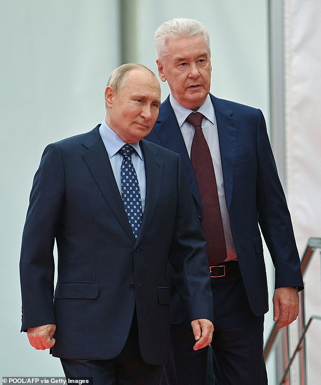 Mayor Sergei Sobyanin (pictured, behind Putin) today signed a decree saying that Muscovites who agree to Putin's bloody war in Ukraine will receive 1.9 million rubles (£16,760)