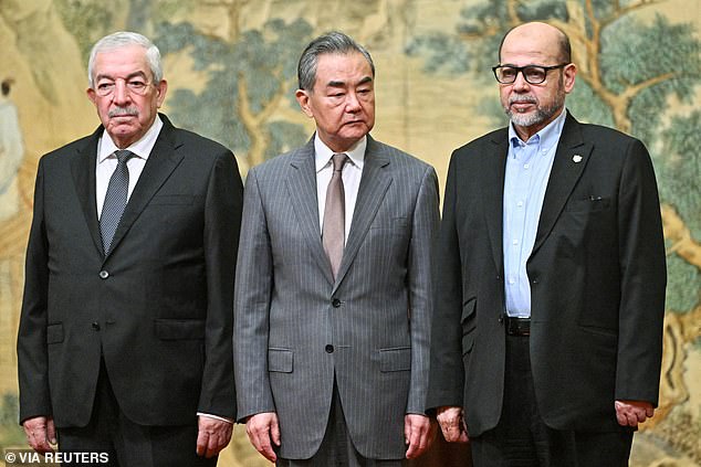 Mahmoud al-Aloul, vice chairman of the Central Committee of the Palestinian organization and political party Fatah, Chinese Foreign Minister Wang Yi and Mussa Abu Marzuk, a leading member of Hamas, attend a meeting in Beijing on Tuesday