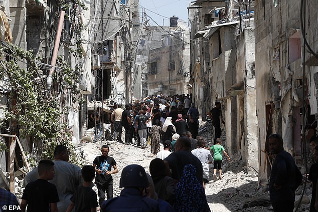 Palestinians inspect damage after an Israeli military operation in the West Bank town of Tulkarem, July 23, 2024