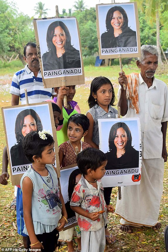 Residents hold placards with a portrait of US Democratic Vice President-elect Kamala Harris as they celebrate her victory in the US elections, in her ancestral village of Thulasendrapuram in the southern Indian state of Tamil Nadu on November 8, 2020. - Residents set off fireworks at Kamala Harris' ancestral home on November 8, as India celebrated the vice president-elect's victory in the US elections, while others hailed her achievement as historic and a "proud moment" for the country. (Photo by STR/AFP) (Photo by STR/AFP via Getty Images)