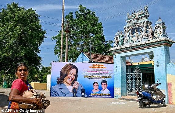 A villager walks past a poster of US Vice President Kamala Harris in her ancestral village of Thulasendrapuram in the southern Indian state of Tamil Nadu on July 23, 2024, after she was endorsed for the presidential election in the fall. (Photo by Idrees MOHAMMED / AFP) (Photo by IDREES MOHAMMED/AFP via Getty Images)