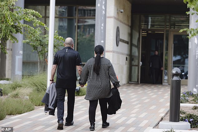 Prosecutors say Mello used the fake organization she created to apply for grants through the military program. (Pictured: Mello with her husband outside the courthouse)