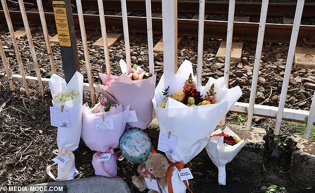 NSW Police are investigating what caused the pram to roll and suspect a simple 'gust of wind' may have caused the accident (Photo: Flowers at Carlton Station in Sydney)