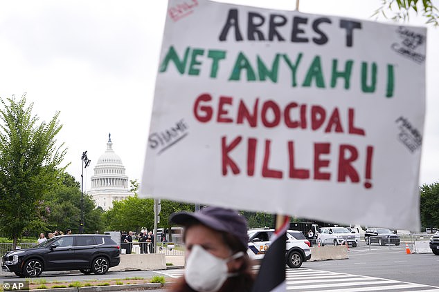 A protester carries a sign in front of the U.S. Capitol on Wednesday